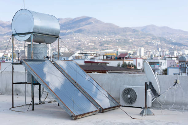 Solar water heater and panels provide hot water and energy efficiency on a rooftop in a sunny city