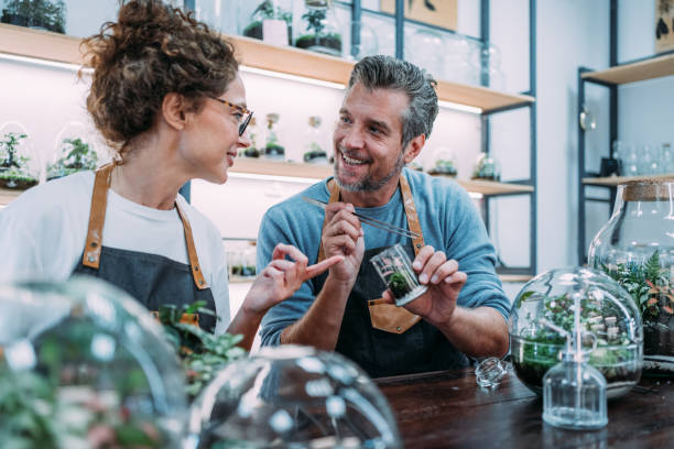 istock Smiling florists arranging green plants. 2196895125