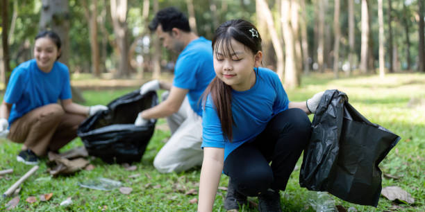 istock Dedicated family volunteers collecting garbage in a park, demonstrating commitment to environmental stewardship and teamwork. 2196895870