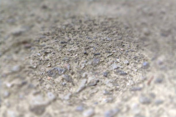 Concrete texture, focus in the center, vignetted frame out of focus.