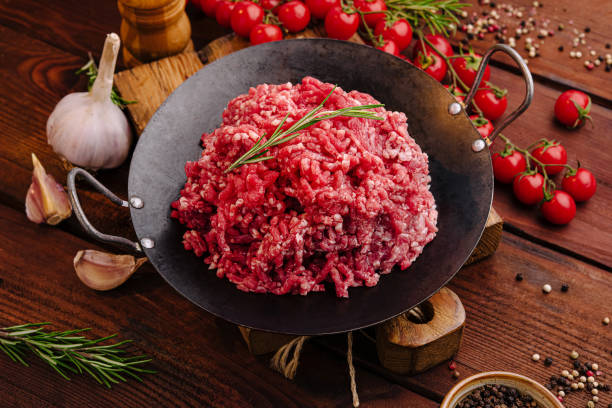 istock Fresh ground beef with herbs and vegetables on rustic wooden table 2196902990