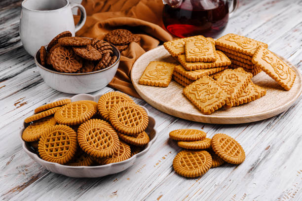 istock Assorted cookies arranged on a rustic wooden table with tea and a cozy atmosphere perfect for sharing 2196904119