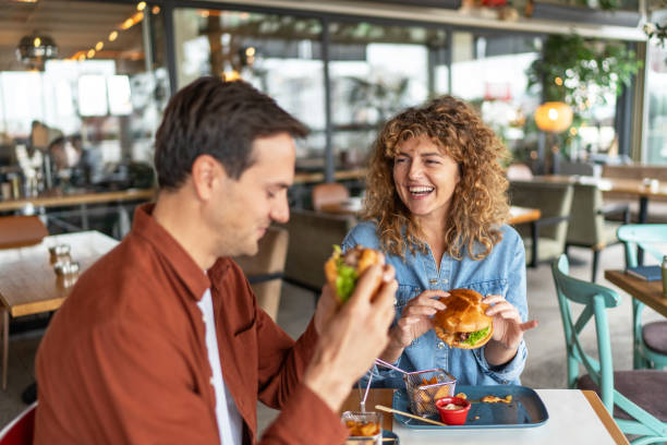 istock Couple having fun and eating burgers 2196905014
