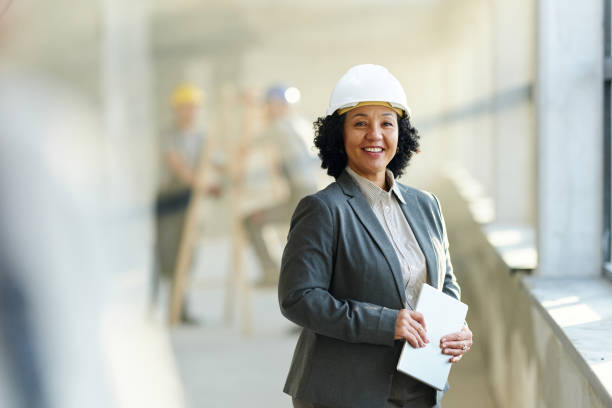 istock Happy female architect holding touchpad at construction site. 2196905068