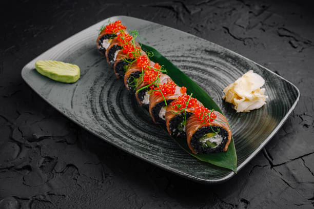 istock Delicious sushi platter presented elegantly on a textured black plate with fresh ingredients and toppings 2196905461