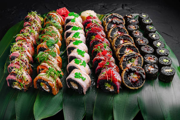 istock Exquisite sushi platter featuring various rolls with fresh ingredients displayed on decorative leaves 2196905462