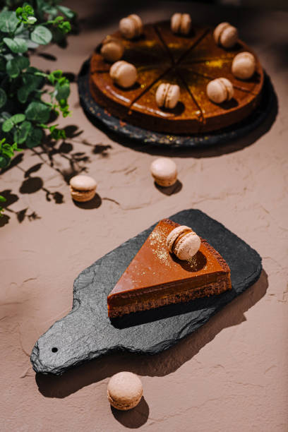 istock Delicious chocolate cake with macarons presented on a rustic surface in a cozy outdoor setting 2196905633