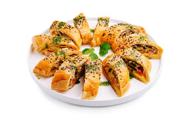 istock Freshly baked savory rolls arranged beautifully on a white platter with sesame seeds and herbs 2196905817