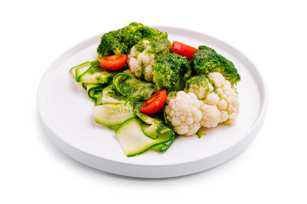istock Fresh vegetable medley featuring broccoli, cauliflower, and cherry tomatoes on a white plate 2196905828