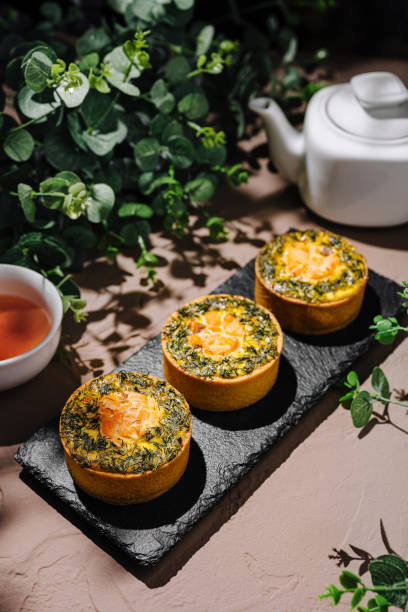 istock Delicious savory pastries with herbs and a cup of tea on a rustic table 2196906253