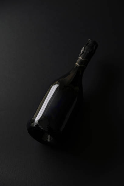 istock Black bottle of sparkling wine set against a dark background highlighting its elegant shape and design 2196906394