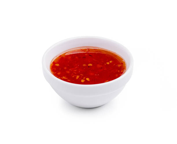 istock Tangy red dipping sauce in a white bowl on a plain background, perfect for appetizers or snacks 2196906458