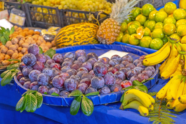 A young woman buys fresh fruits and vegetables at the market