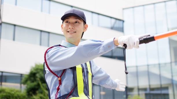 Asian traffic controller directing traffic stock photo