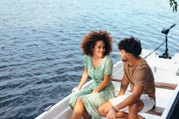 istock Young couple enjoying a romantic boat trip on a lake 2196907954