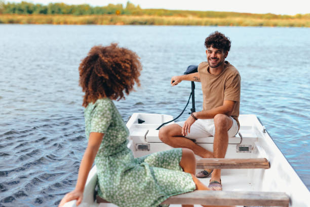istock Young couple enjoying a romantic boat trip on a lake 2196907968