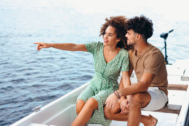 istock Young couple enjoying romantic moments while boating on a lake 2196907970