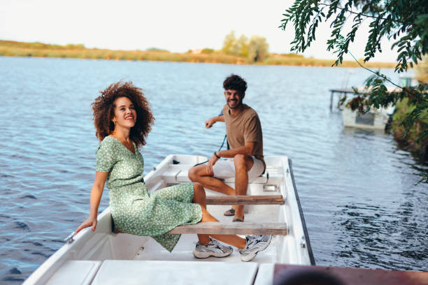 istock Young couple enjoying a romantic boat trip on a lake 2196907976