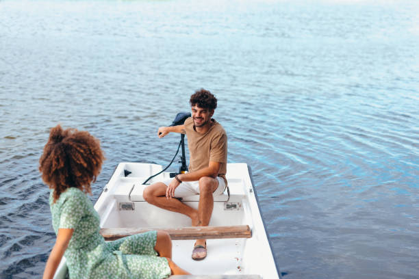 istock Young couple enjoying a romantic boat trip on a sea 2196907977