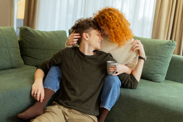 istock Joyful moments shared between a couple in a cozy living room filled with sunlight and warmth, highlighting affection and togetherness 2196909430
