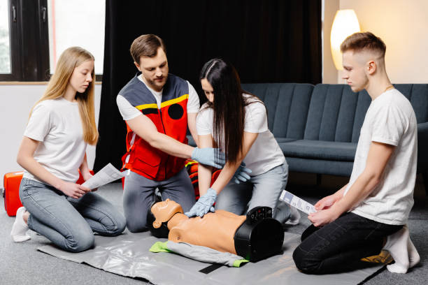 istock Group of people learning how to make first aid heart compressions with dummies during the training indoors 2196909530