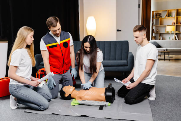 istock Group of people learning how to make first aid heart compressions with dummies during the training indoors 2196909534