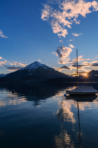istock Sunset with sun burst over the Niesen Mountain (socalled Swiss Pyramid) 2196915860