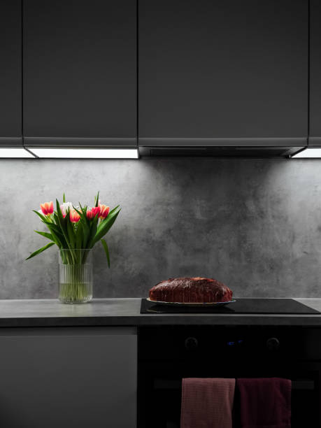 istock Prague kitchen counter displaying vibrant tulips, freshly baked cake, soft under cabinet lighting creating warm ambiance for Mother's Day Valentines copy space 2196915868