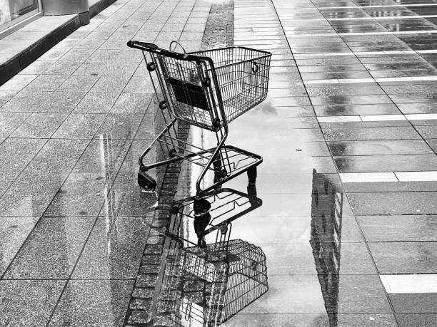 istock Shopping trolley in a wet road 2196916333