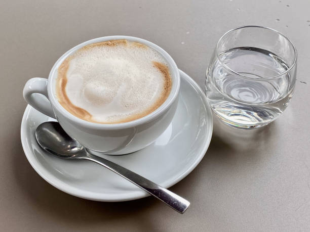 istock Cappuchino with a glass of water 2196916343