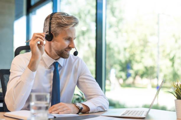 istock Portrait of call center worker. Smiling customer support operator at work 2196916728