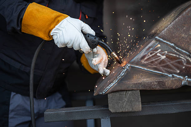 istock Worker welding metal with sparks flying at industrial workshop 2196923050