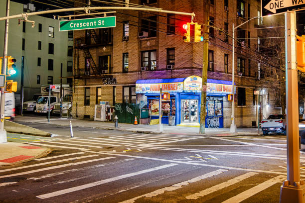 Long Island City, Queens, New York, United States - January 2th 2025:  In the residential parts of New York there are many small convenience stores. This one is photographed at a clear winter night in Long Island City