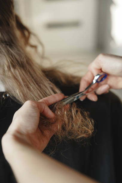 istock Cutting curly hair dry. CGM method. Curly girl method. Back view, vertical photo 2196924113