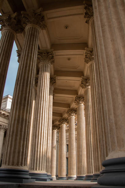 istock Symmetrical Vertical view Ancient Greek Stone Corinthian Fluted Columns showcasing Architecture Kazan Cathedral St Petersburg. Sunlight breaks through Colonnade forming laconic shadows on the flutes 2196924152