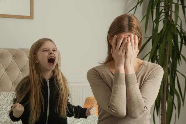istock Stressed mother feeling desperate about stubborn daughter who screams. 2196925088