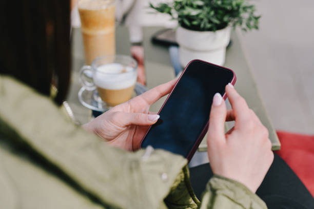 istock Female Using Telephone While Being on Coffee Date With Friend 2196926216