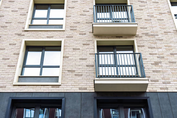 istock Modern apartment building facade with balconies and brick wall exterior 2196927363