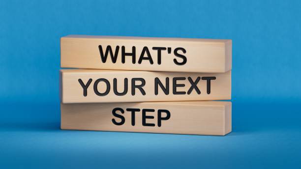 What is your next step symbol.words What is your next step. Business concept. Wooden cube blocks. Copy space.3D rendering on blue background.