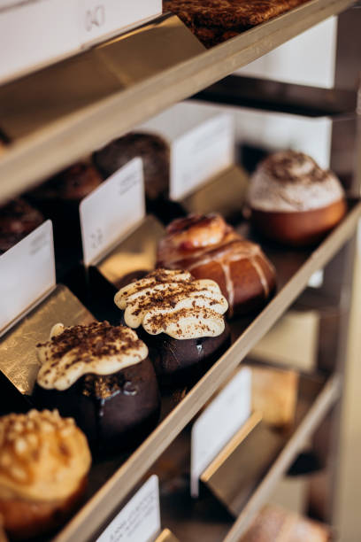 istock Appetizing cinnamon buns with cream in the bakery window. 2196928827