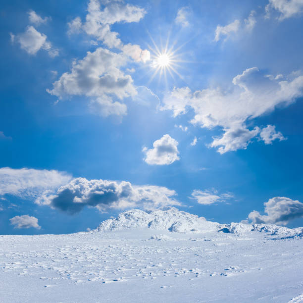 mountain ridge in snow under a sparkle sun
