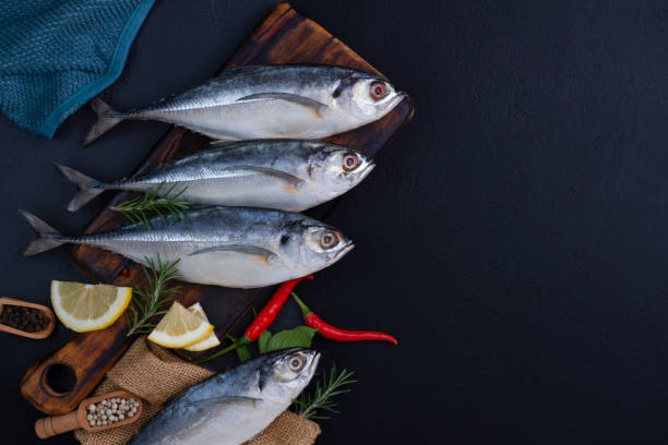 istock Raw mackerel, seafood, ready to cook on black background 2196929401