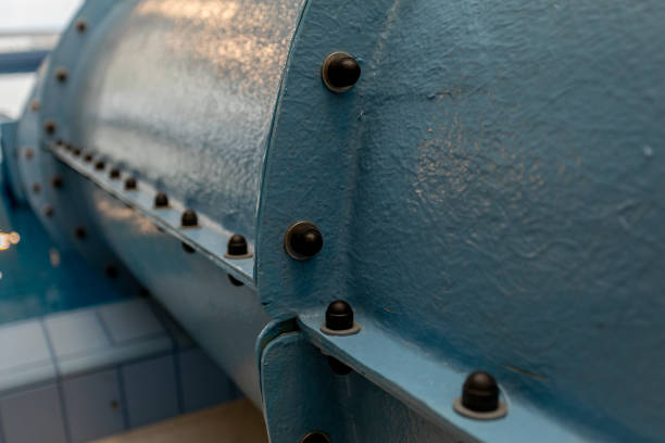 Detailed view of a blue industrial pipe featuring rivets and textured surface, showcasing engineering design.
