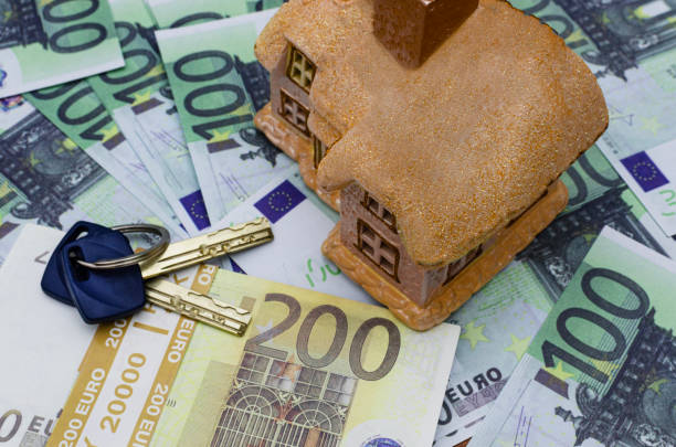 istock Keys and a toy house on euro banknotes 2196930090