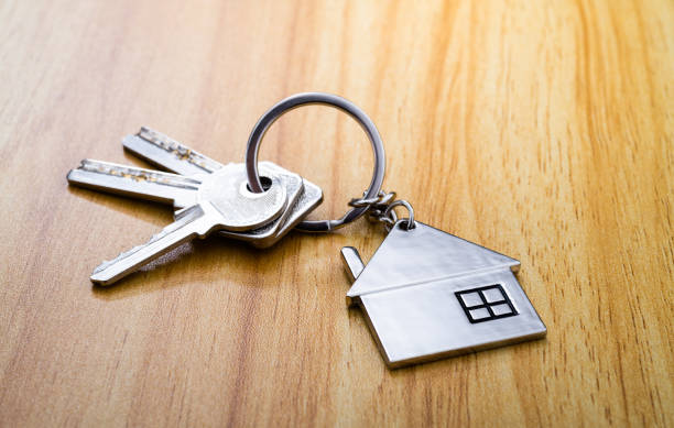 istock House shaped with a key on wooden table 2196931452