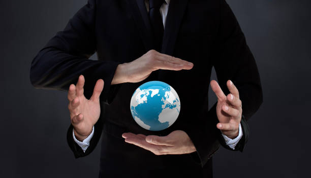 The Earth Controlled by New Artificial Intelligence Technology Humans who manage AI-based systems will have more control over the world. An AI-powered scientist holding a spinning blue world in his four hands. / You can see the animation movie of this image from my iStock video portfolio. Video number: 2194760898 finger spinning globe stock pictures, royalty-free photos & images