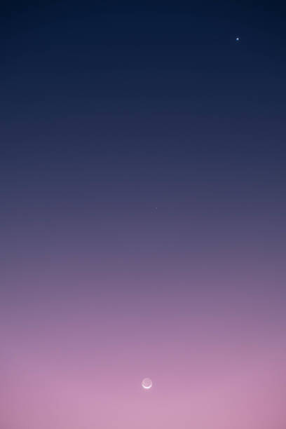 istock Crescent moon along with planets Saturn and Venus in the evening sky 2196934477