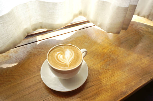 Latte coffee on wooden table, Close up shot