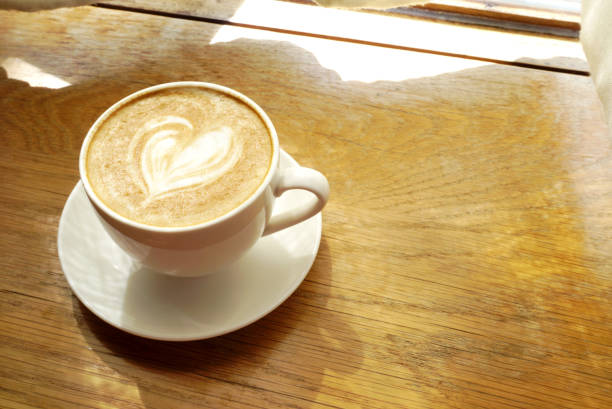 istock Latte coffee on wooden table, Close up shot 2196934925