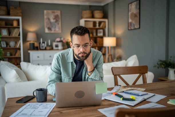 istock Man working remotely in his home office, fully engaged 2196935490
